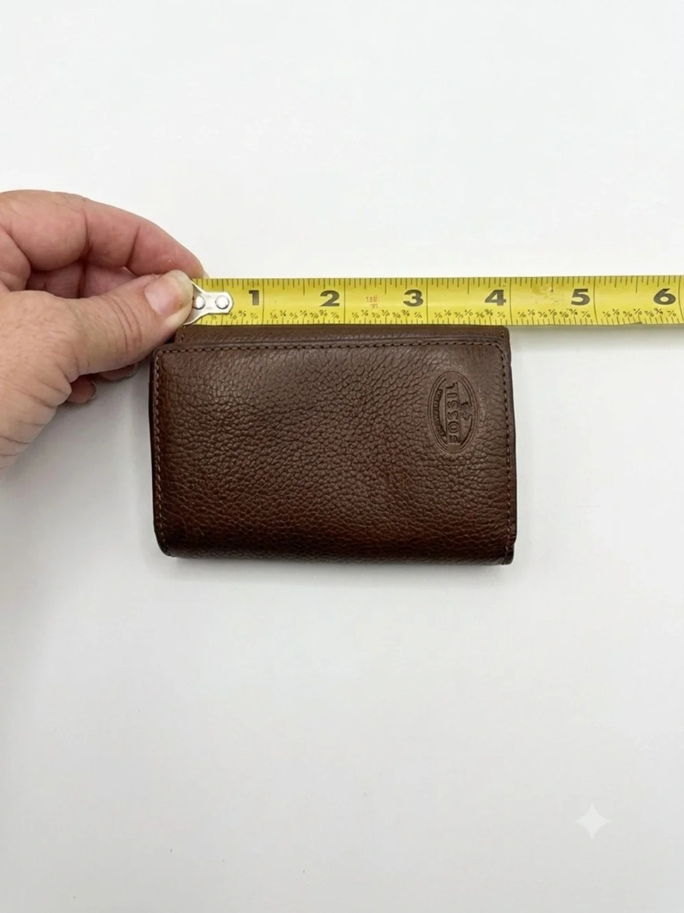leather Fossil tri-fold key holder wallet featuring six metal key hooks.